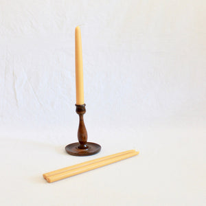 Pure beeswax candles in an arts and crafts hand turned wooden candlestick